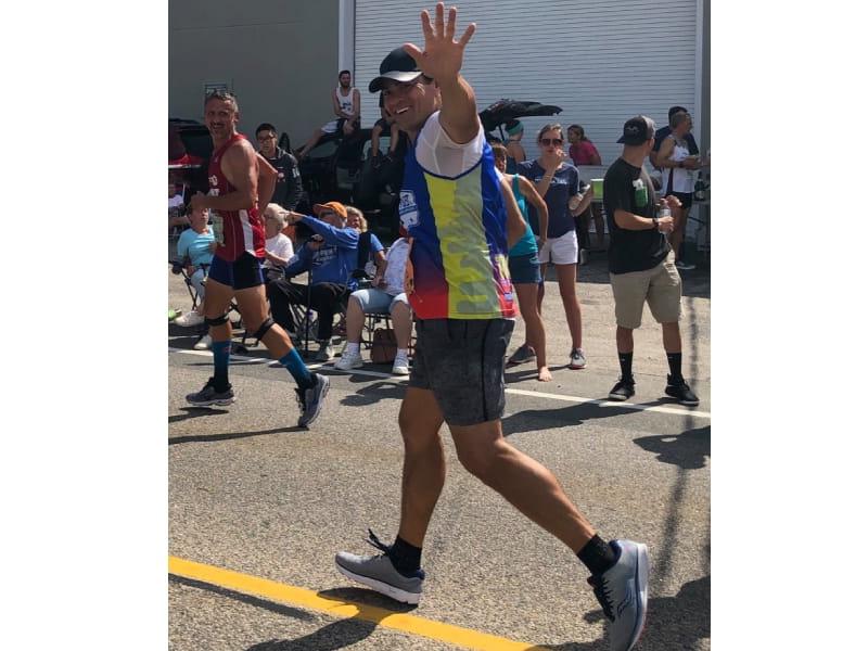 Tedy Bruschi waves as he runs in Falmouth, Mass. (Photo courtesy of Tedy's Team)